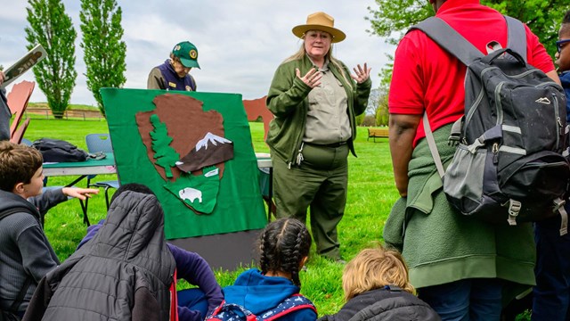 A ranger talking to a group of visitors behind the visitor center.